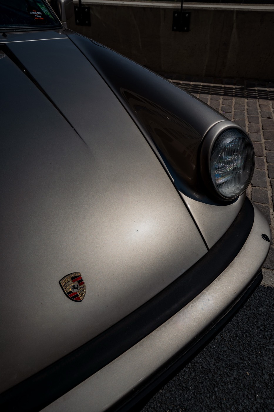 Porsche 911 Carrera headlight and badge close up