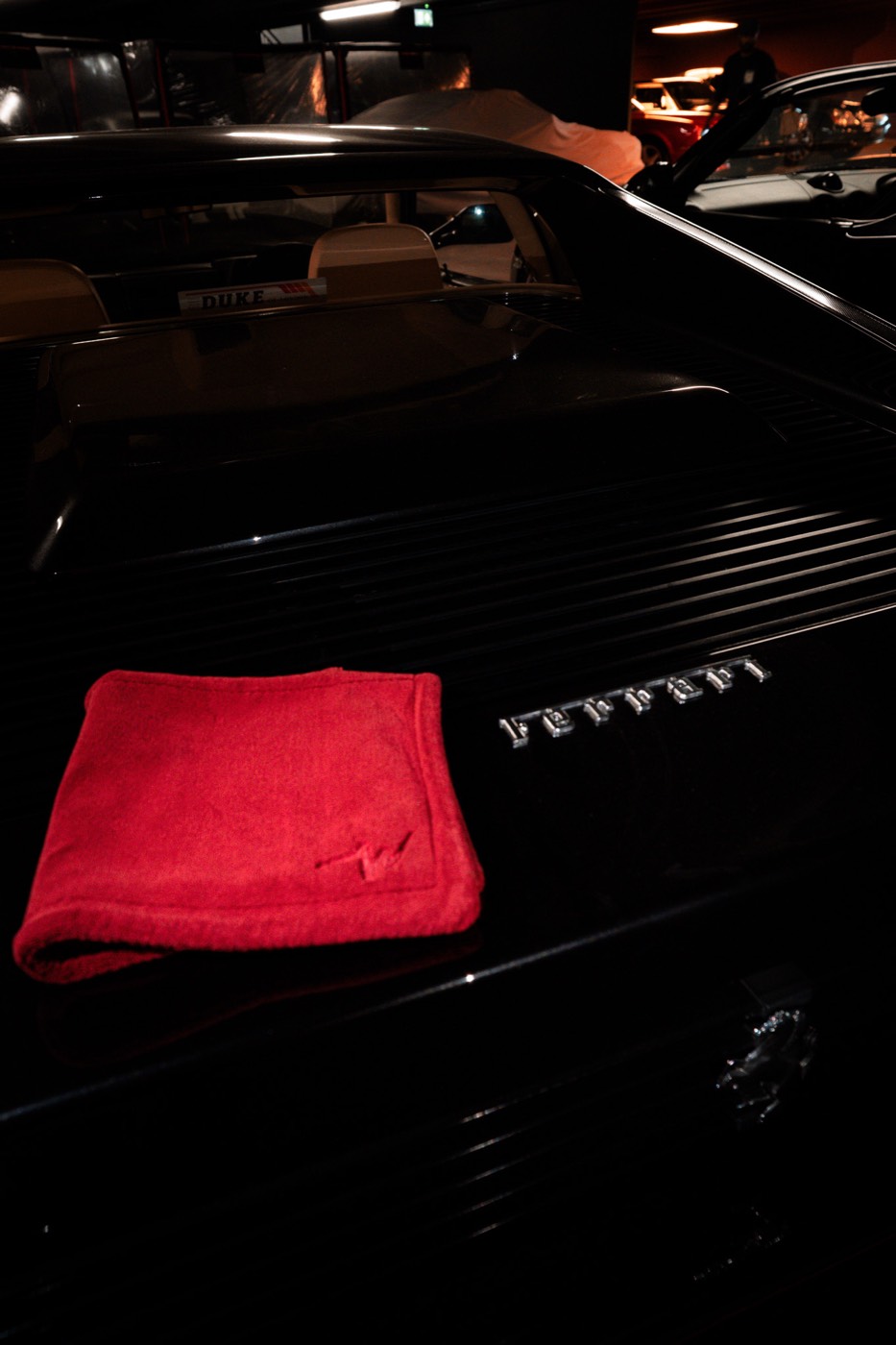 wype towel on a black Ferrari Testarossa in Duke of London's showroom