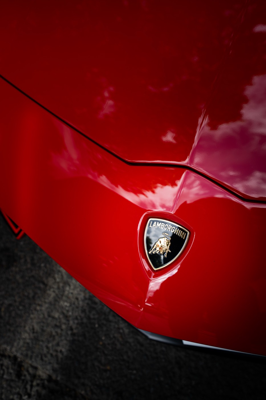 Lamborghini badge close up on red Aventador SVJ bonnet