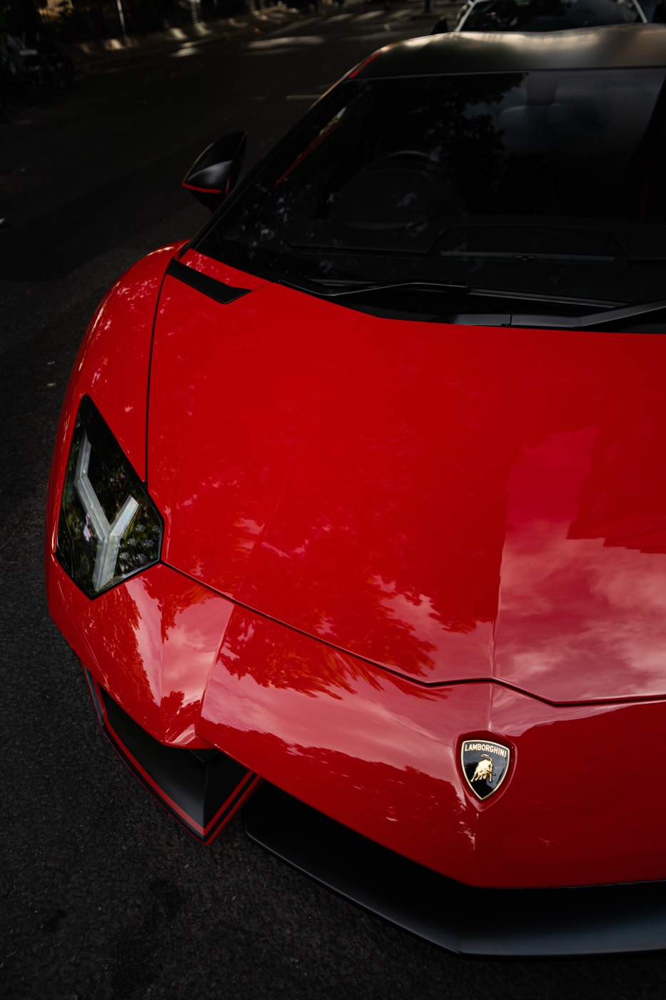 Front end and headlight of a red Lamborghini Aventador SVJ