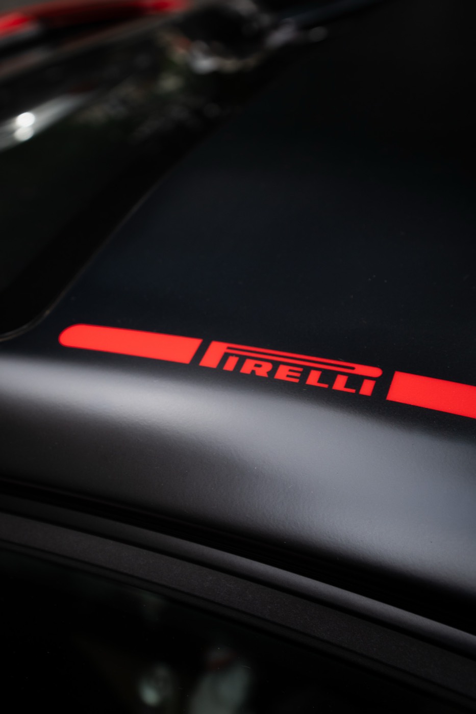Pirelli decal on the bonnet of a matte black supercar