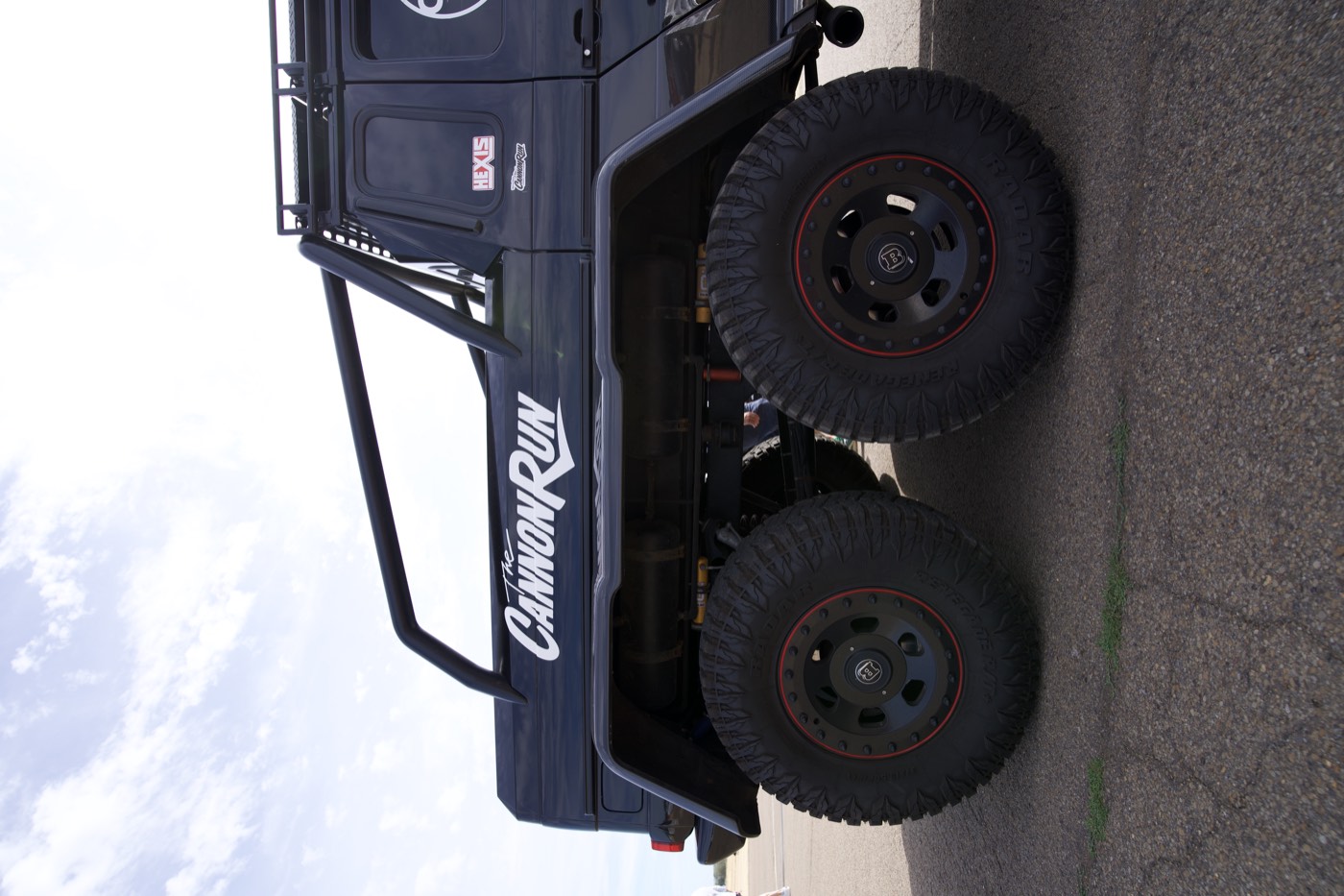 Side profile of the Brabus 700 6x6 Cannon Run truck showing its six wheels