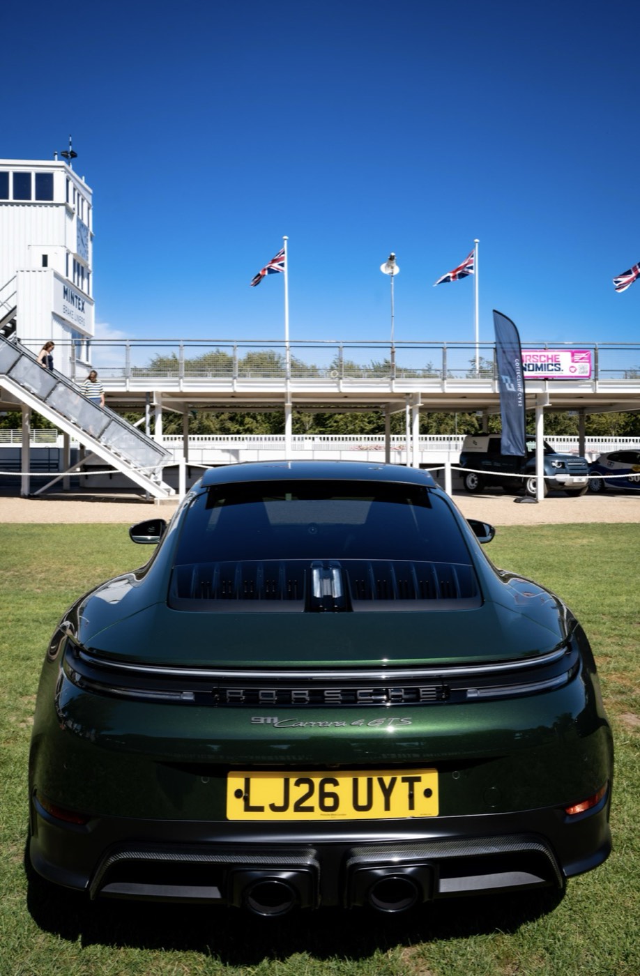 Green Porsche 911 Carrera 4 GTS in front of the Goodwood grandstand
